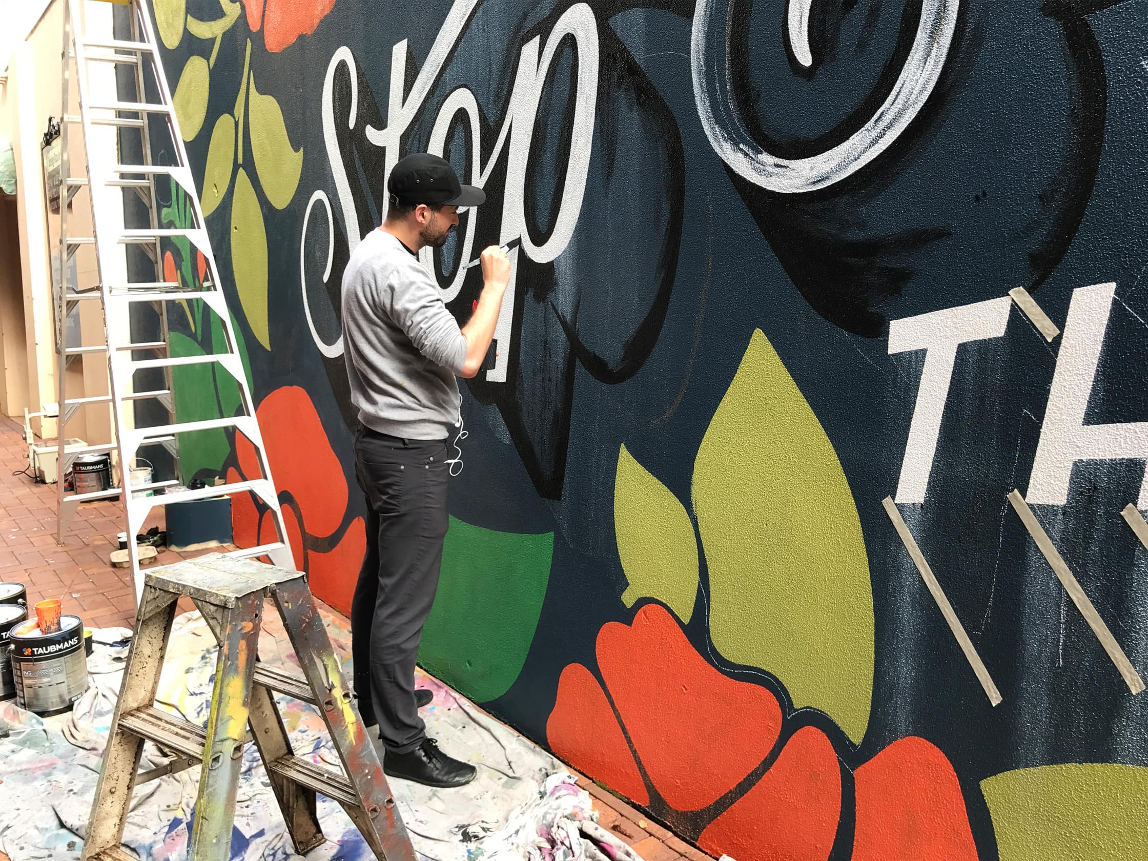 Mural Painting with the Outlier Slim Dungarees in Toowoomba Australia