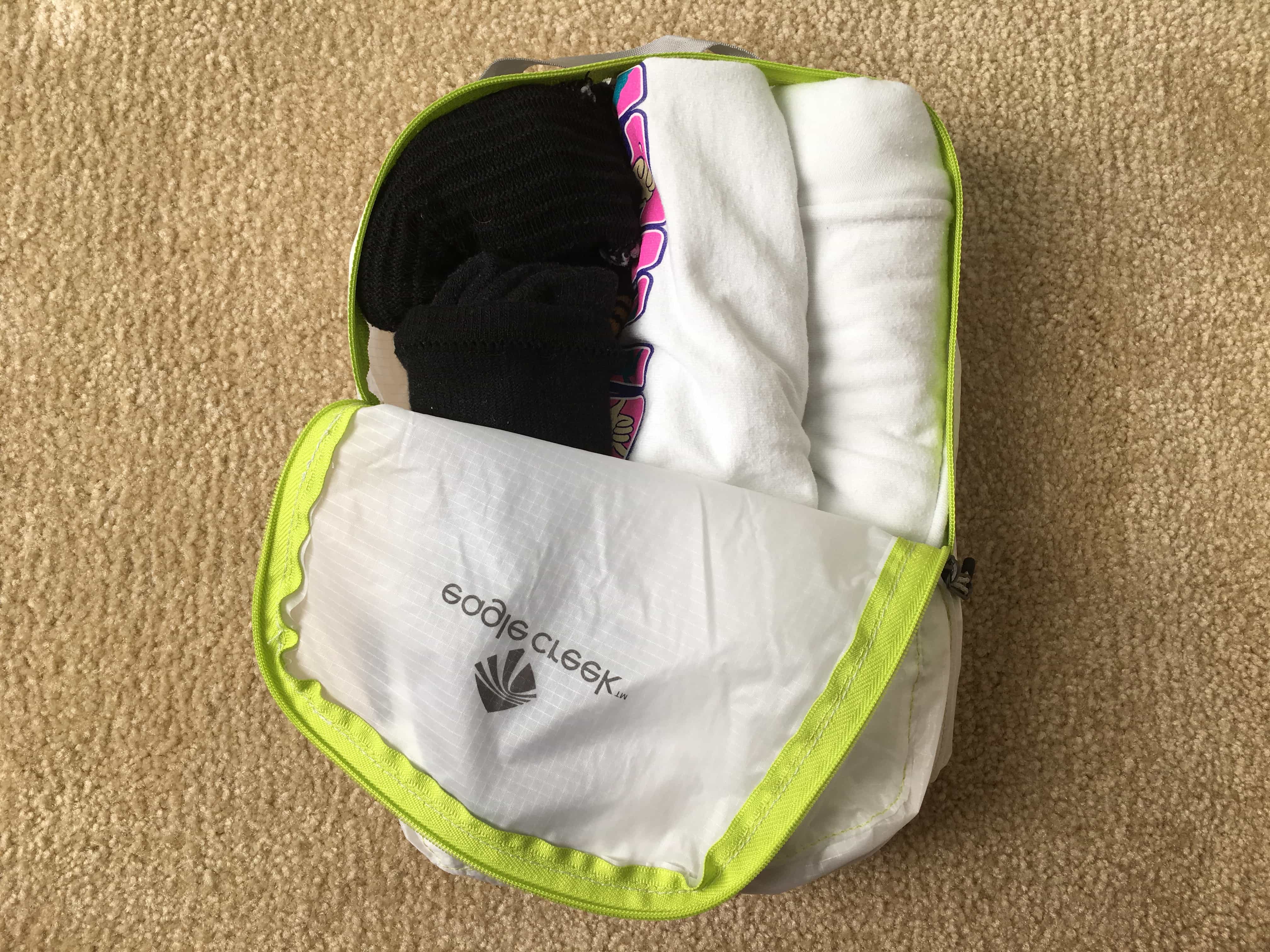 Two tees and three socks inside the Eagle Creek Pack-It Specter Cube size small