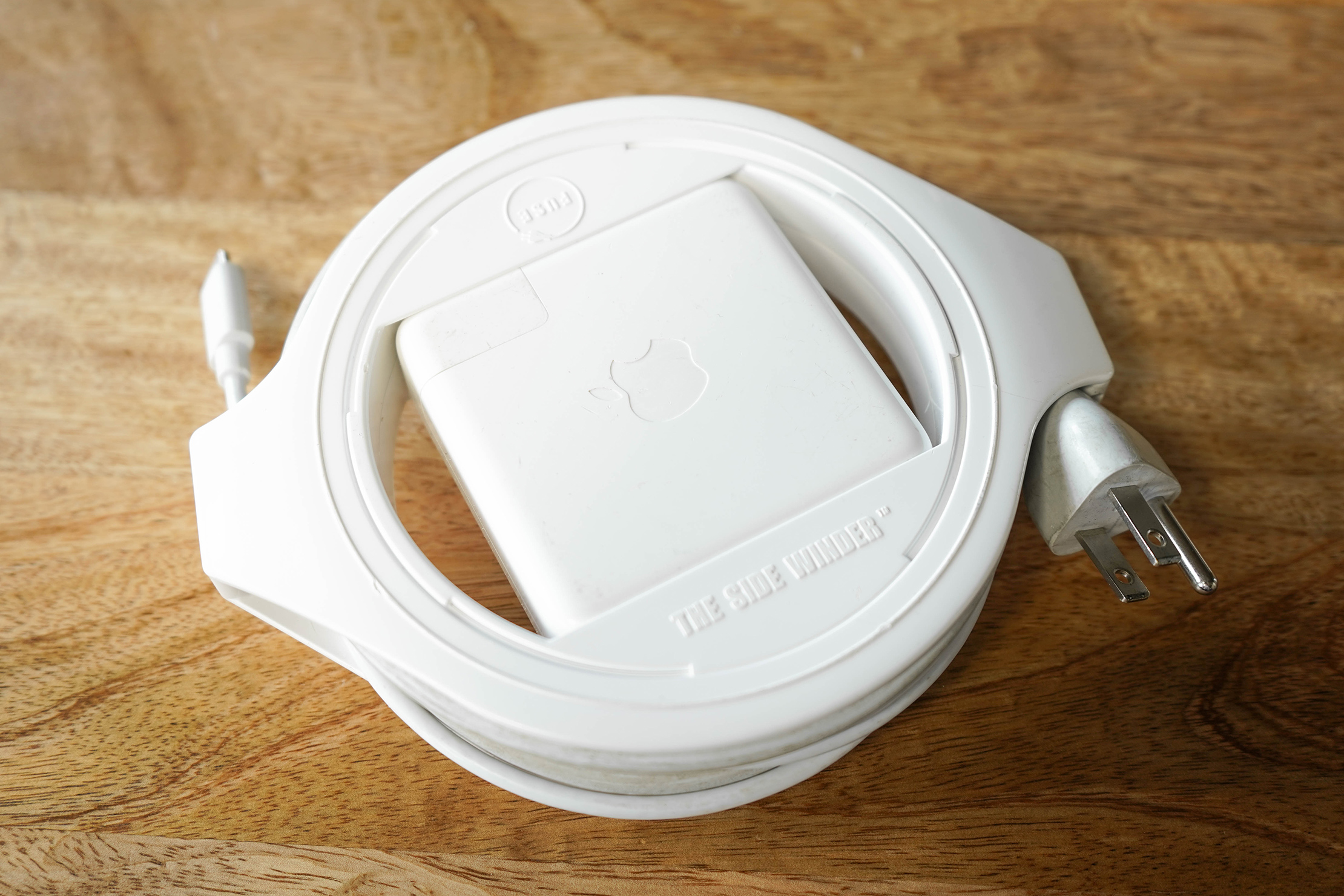 Side Winder reels in MacBook's charger cables