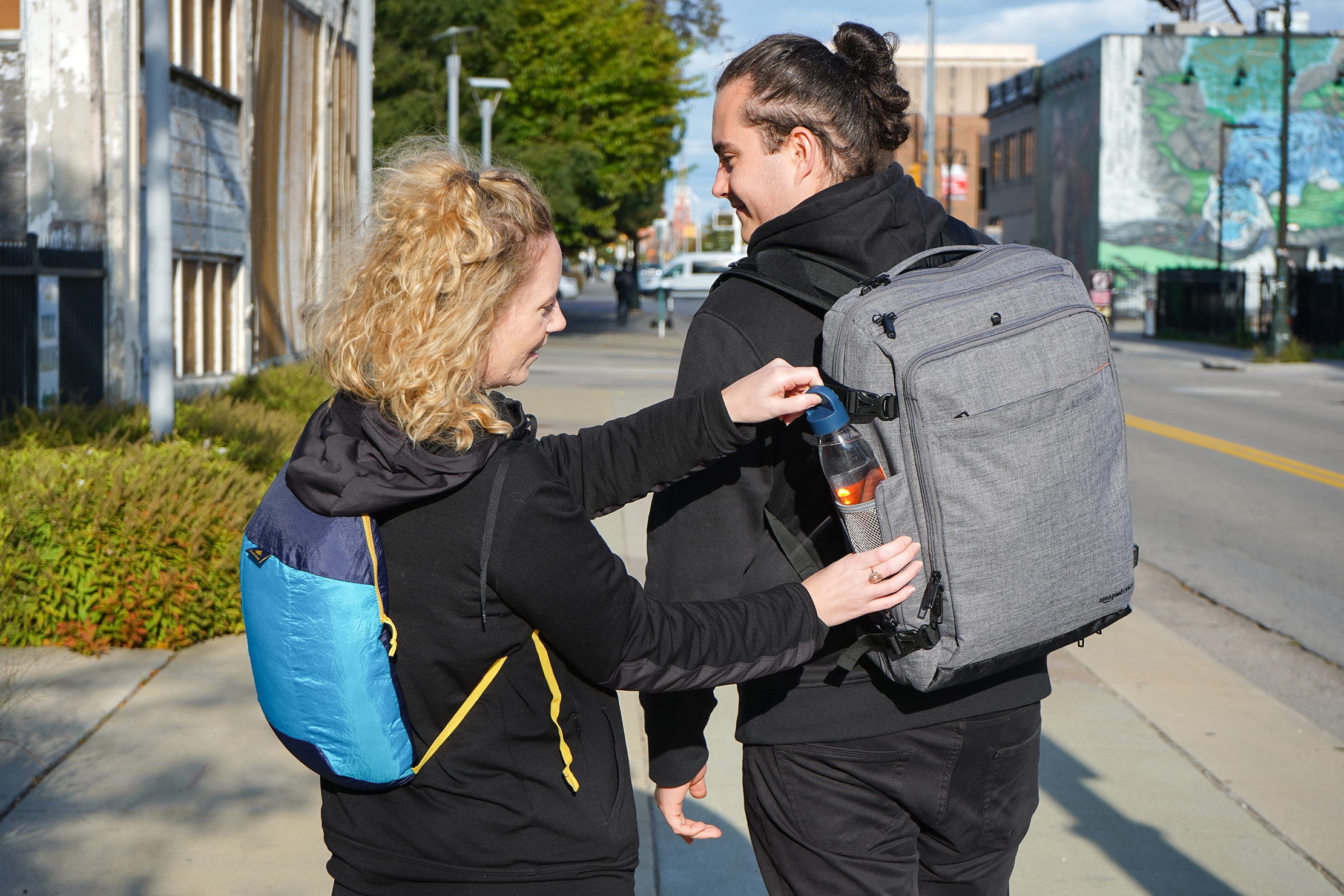 Carrying The Quechua Packable Backpack & AmazonBasics Slim Carry On Weekender In Detroit, Michigan