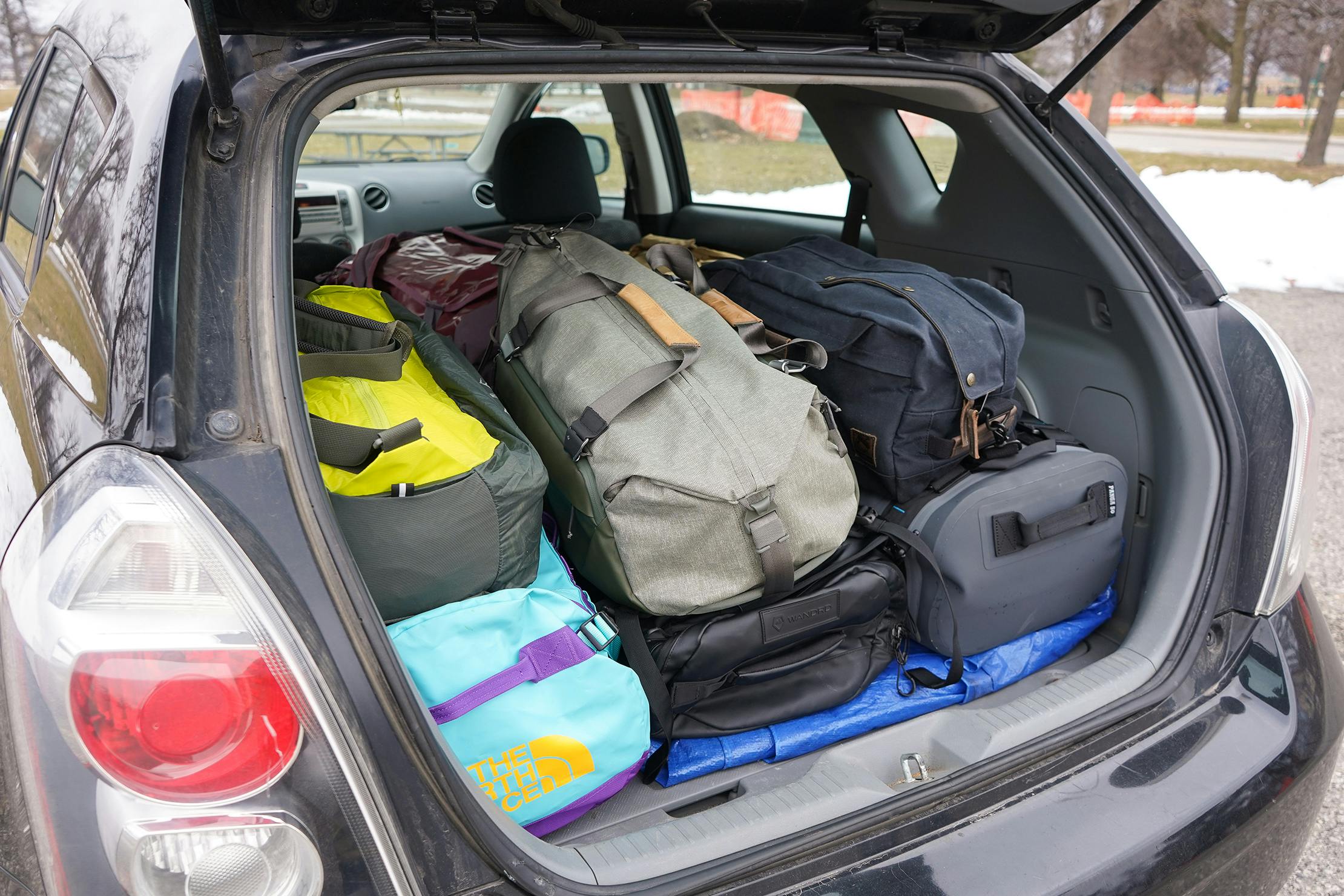 Car packed with duffle bags