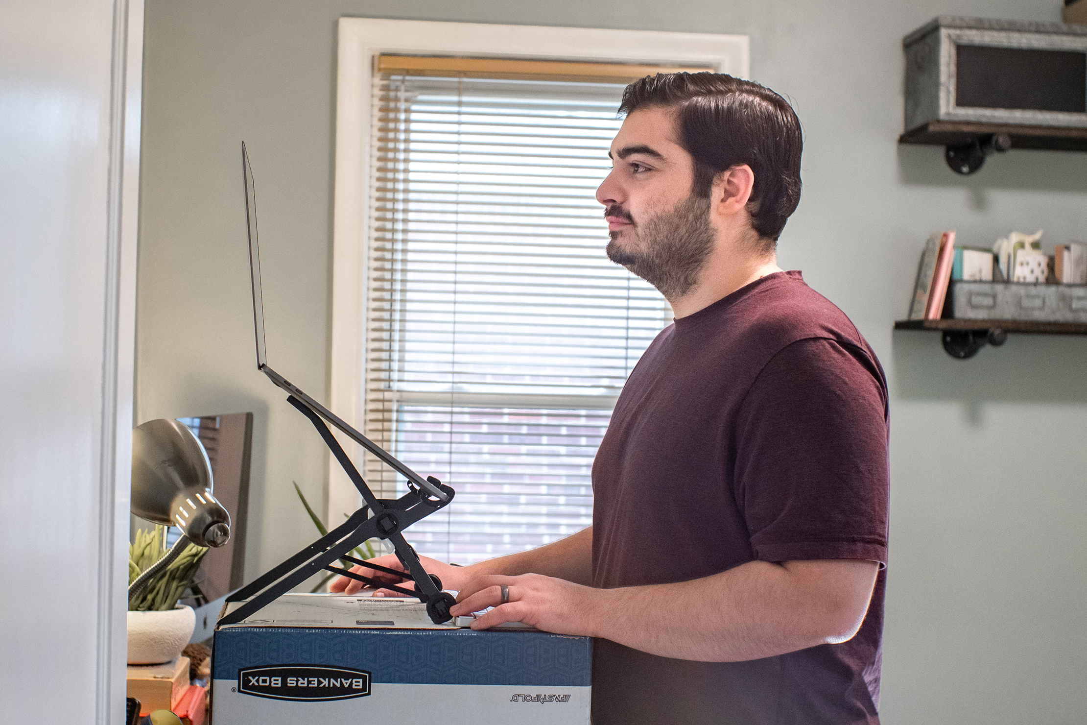 Working From Home At A Standing Desk Made Out Of Cardboard Boxes