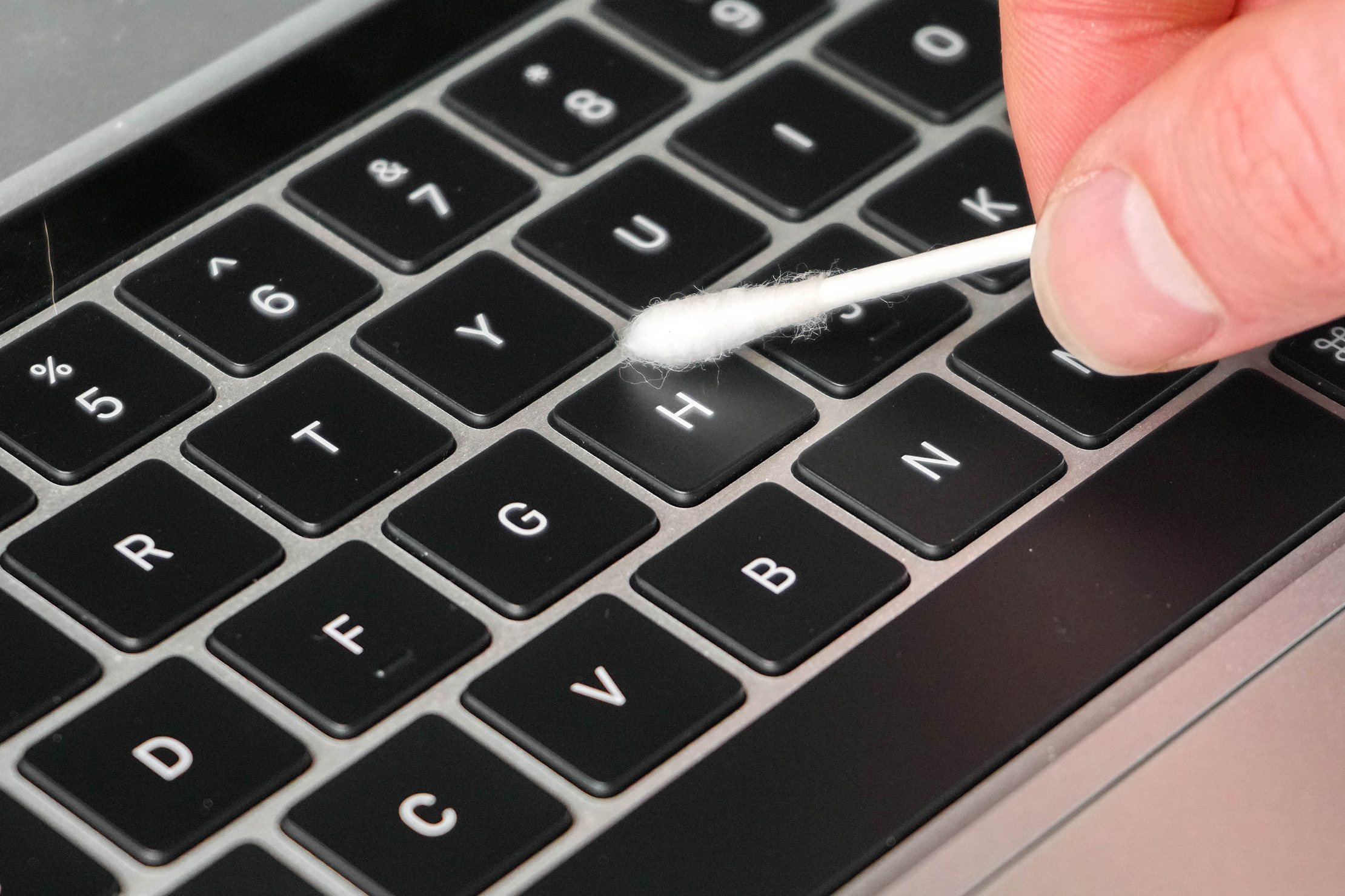 Cleaning Keyboard with Cotton Swab
