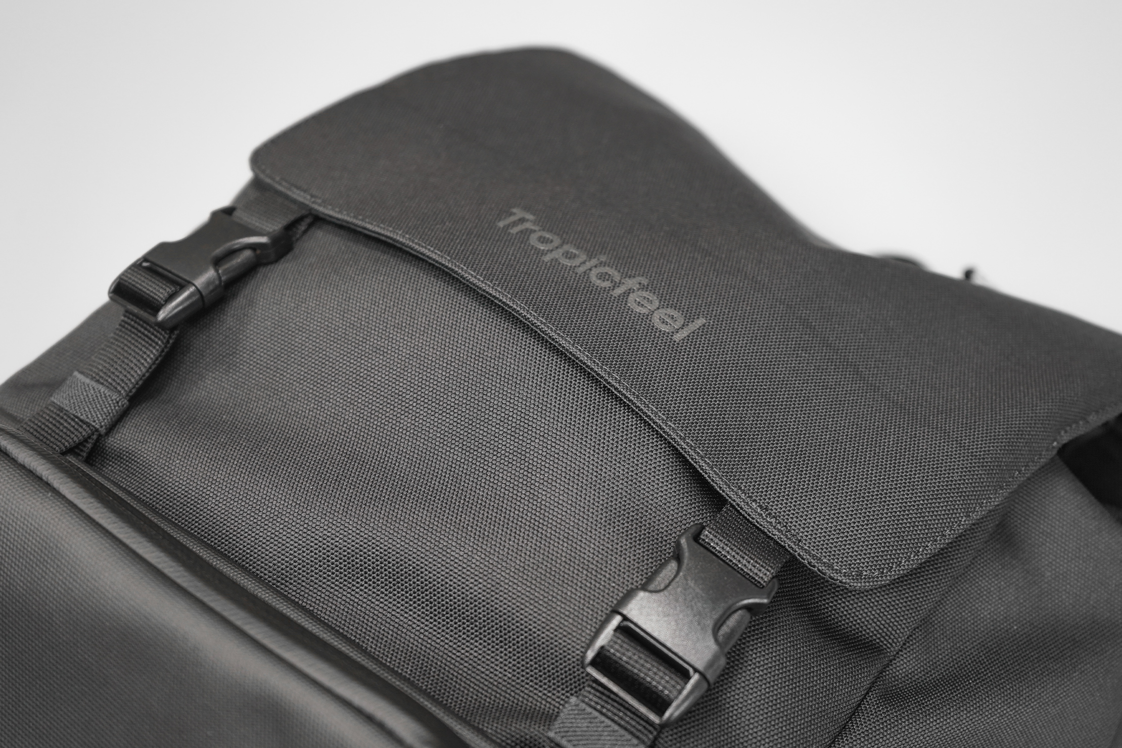 Tropicfeel Shell Travel Backpack | The grey-on-black logo is hardly noticeable