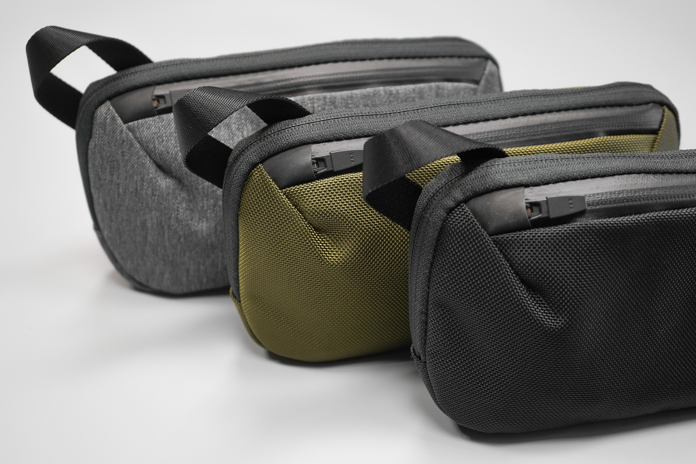 Aer Slim Pouch | From left to right comes Heathered Grey, Olive, and Black