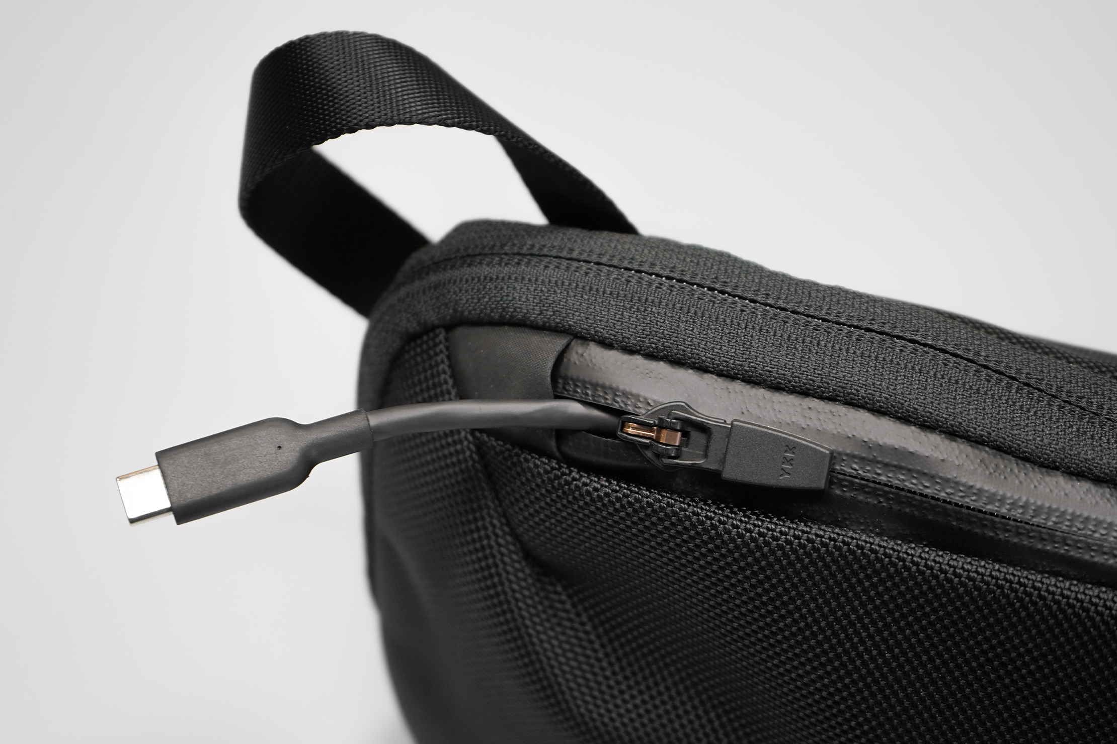 Aer Slim Pouch | Feel free to yank on your cable as long as the zipper tab's down