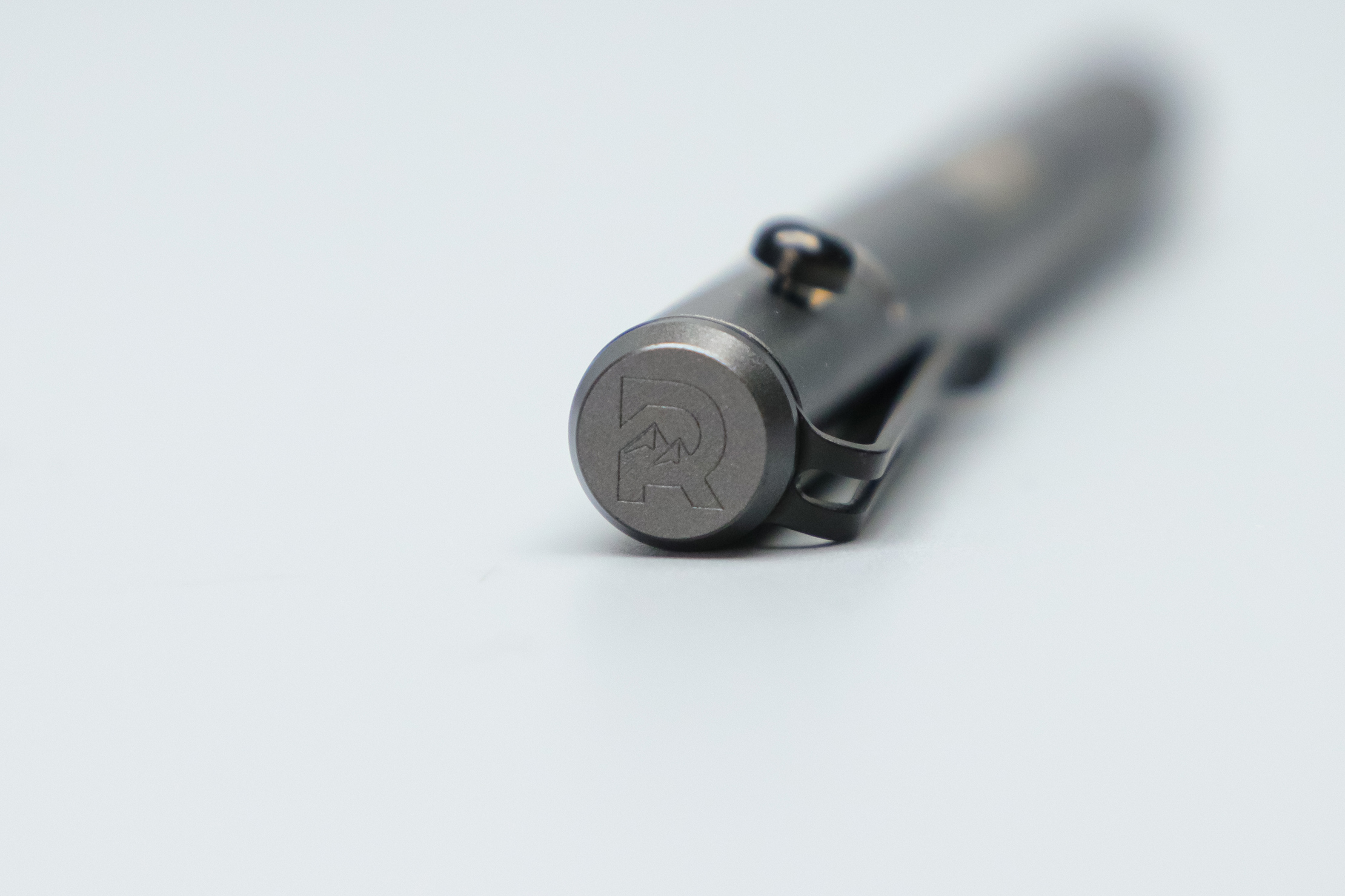 The Ridge Bolt Action Pen R logo