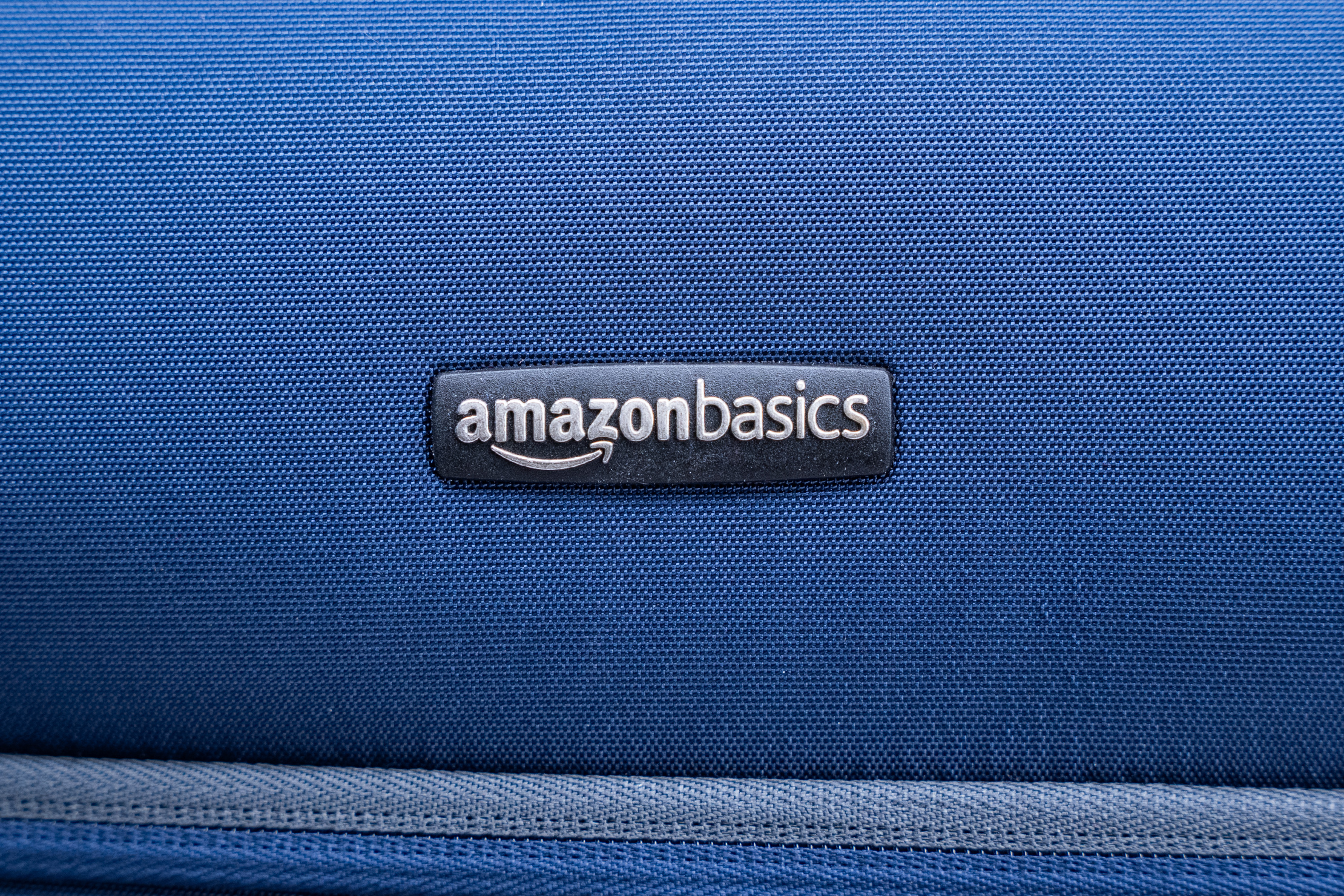 Amazon Basics Softside Spinner Suitcase (21 inch) Logo