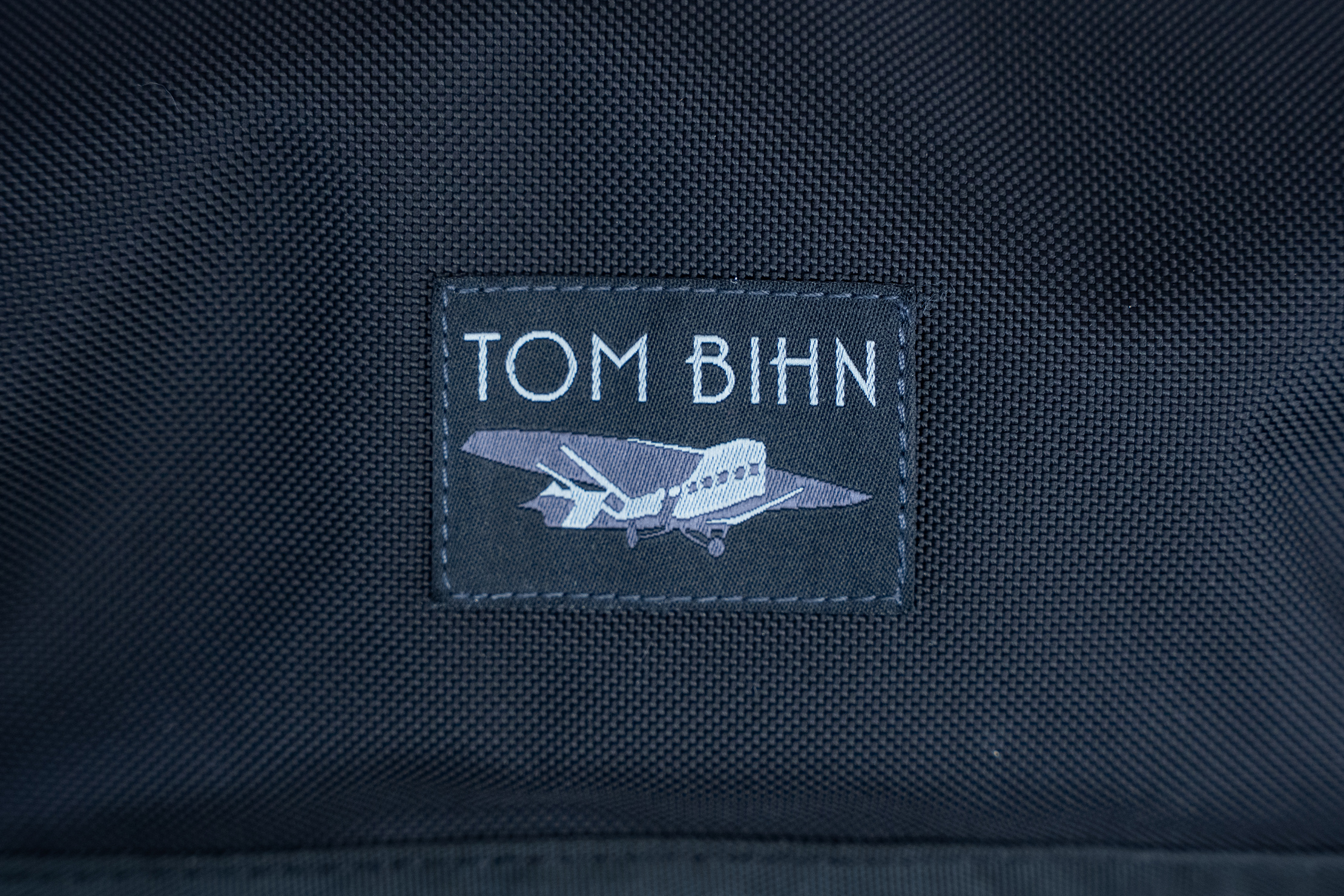 TOM BIHN Marathon Messenger Bag Logo